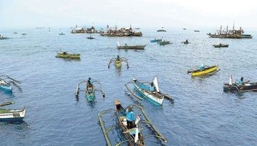 About 100 fishing boats sail toward Pan- atag Shoal during the second civilian-led resupply mission by the Atin Ito Coalition yesterday.