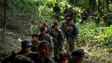 This photo taken on July 30, 2017 shows guerrillas of the New People's Army (NPA) marching in the Sierra Madre mountain range, located east of Manila. Fuelled by one of the world's starkest rich-poor divides, a Maoist rebellion that began months before the first human landed on the moon plods on even though the country now boasts one of the world's fastest-growing economies.