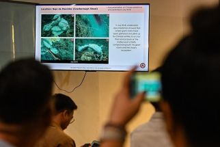 A journalist takes a photo of a presentation by the Philippine Coast Guard showing alleged Chinese activities in Scarborough Shoal, during a press conference in Manila on May 20, 2024. 