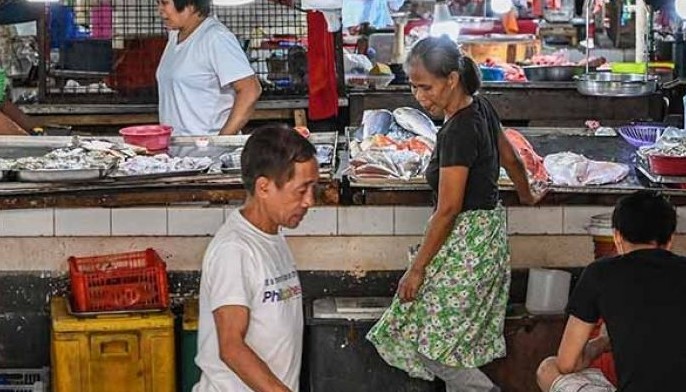 Vendors wait for customers at a market in Manila on May 9, 2024.