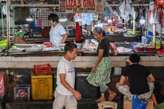 Vendors wait for customers at a market in Manila on May 9, 2024.
