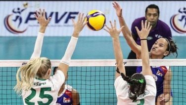 Siri Rondina of Alas Pilipinas attacks the defense of  Australia during the AVC Challenge Cup at the Rizal Memorial Coliseum in Manila.