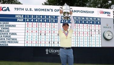 Yuka Saso of Japan poses for a photograph with the Harton S. Semple trophy in front of the scoreboard following the final round of the US Women's Open Presented by Ally at the Lancaster Country Club on June 02, 2024 in Lancaster, Pennsylvania