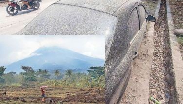 A woman stands on a lot near her house at the foot of Mt. Kanlaon in La Castellana, Negros Occidental province yesterday, a day after the volcano erupted. Top photo shows a parked vehicle covered in volcanic ash in La Castellana. 