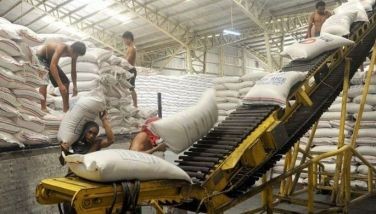 Workers are unloading truck load of rice at the warehouse of the National Food Authority (NFA) in suburban Manila on October 7, 4014. 