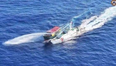 In this frame grab from aerial video footage taken on March 5, 2024 and released by the Philippine Coast Guard (PCG), a Chinese Coast Guard ship (R) deploys a water cannon at the Philippine military-chartered civilian boat Unaizah May 4 (L) during its supply mission near Second Thomas Shoal in the disputed South China Sea. The Philippines said on March 5 that China Coast Guard vessels caused two collisions with Philippine vessels and water cannoned a boat, leaving four crew injured during a resupply mission in the South China Sea. 