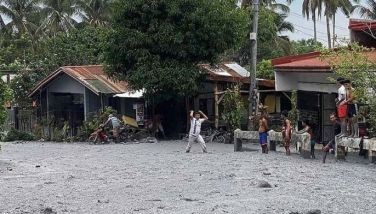 This handout photo taken and released on June 5, 2024 by the Office of the Protected Area Superintendent of Mount Kanlaon Natural Park shows residents wading through lahar from the eruption of Mount Kanlaon volcano along a road in Biaknabato village in La Castellana municipality, Negros Occidental province.