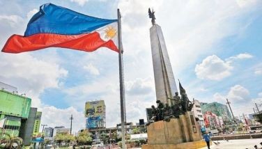 A worker cleans the Andres Bonifacio Monument in Caloocan City in preparation for the 126th Philippine Independence Day rites on June 12.