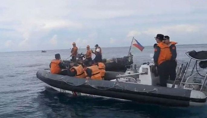 This handout photo grabbed from a video released by the Philippine Coast Guard on June 7, 2024 shows Chinese Coast Guard personnel aboard their rigid inflatable boat, blocking a Philippine Coast Guard rigid inflatable boat (back) carrying marine scientists in the waters of the South China Sea. The Philippine Coast Guard said on June 7, that Chinese boats &quot;harassed&quot; their vessel during a medical evacuation last month of a Filipino soldier, who was stationed on a remote outpost in the South China Sea.