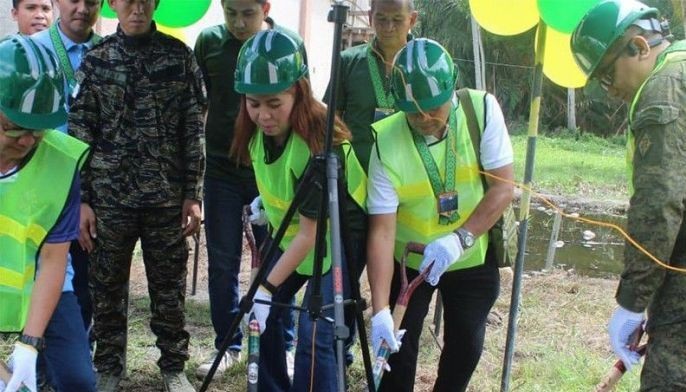 Non-Muslim Soldiers fixing dilapidated mosque, school building