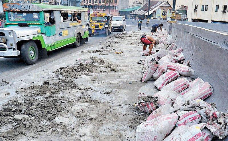 Sacks of cement fall from truck on Quezon Bridge