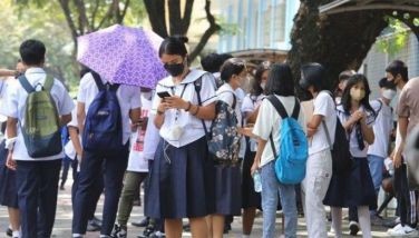 High school students wait for their time in front Marikina High School in Marikina.