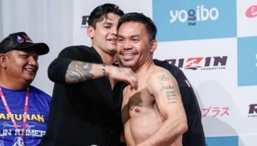 Ryan Garcia and Manny Pacquiao greet each other during Saturday's weigh-in rites.