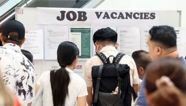 Jobseekers view vacancies and fill out forms as they apply for work in various participating companies at a job fair sponsored by the local government at a mall in Greenhills, San Juan City on May 3, 2024.