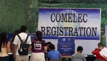 Residents fill out forms as they line up at a Commission on Elections (Comelec) satellite voter's registration at a mall in Masinag, Antipolo, Rizal on August 20, 2024. 