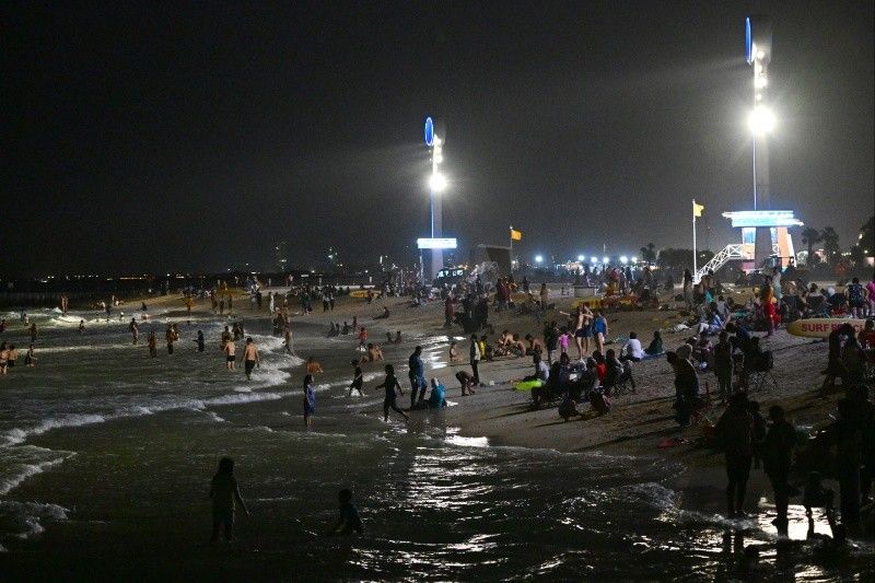 Too hot by day, Dubai's floodlit beaches are packed at night