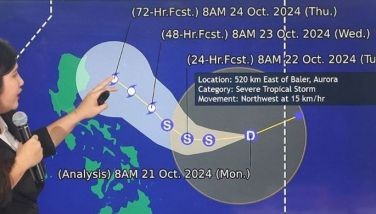 A weather forecaster from the Philippine Atmospheric, Geophysical and Astronomical Services Administration (PAGASA) explains their forecast of Tropical Depression Kristine track throughout the country during a press conference at the PAGASA head office in Quezon City on Oct. 21, 2024.