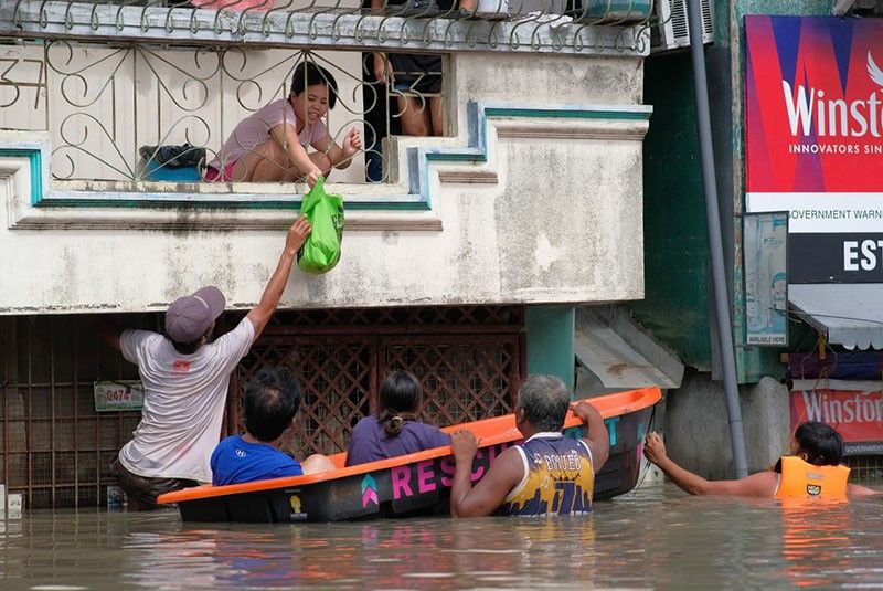 Philippine rescuers battle floodwaters to reach stranded