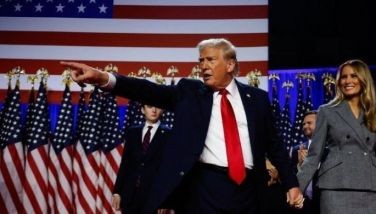 Republican presidential nominee, former U.S. President Donald Trump points to supporters with former first lady Melania Trump during an election night event at the Palm Beach Convention Center on November 06, 2024 in West Palm Beach, Florida. Americans cast their ballots today in the presidential race between Republican nominee former President Donald Trump and Vice President Kamala Harris, as well as multiple state elections that will determine the balance of power in Congress.