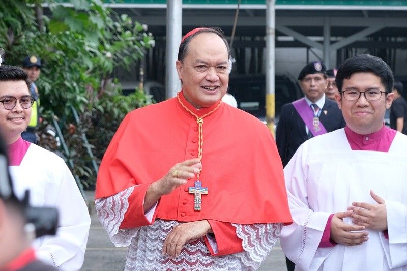 Cardinal David wears Romero cross