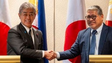 Japan's Foreign Minister Takeshi Iwaya (L) and Philippine Foreign Minister Enrique Manalo shake hands after a joint press conference in Manila on Jan. 15, 2025.