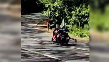 John Louie Arguelles and Rico Bayawan performing stunt riding along Marilaque Highway in Tanay, Rizal on Jan. 26, 2025 