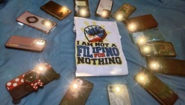Filipino migrant workers turn on their phone flashlights and place them in a circle around a clenched fist symbol to express support for former Philippine president Rodrigo Duterte, at Repulse Bay in Hong Kong on March 16, 2025. Following a brief visit to the Chinese city, Duterte was arrested at the Manila airport on March 11 and later taken before the International Criminal Court, where he faces charges of crimes against humanity over his deadly crackdown on drugs.