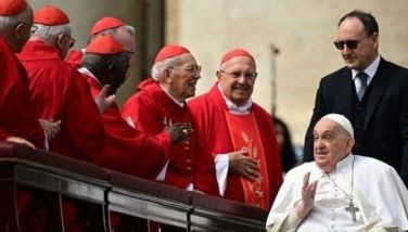 Pope Francis greets cardinals during a surprise appearance at the end of the mass for Palm Sunday at St Peter's square in the Vatican on April 13, 2025. 