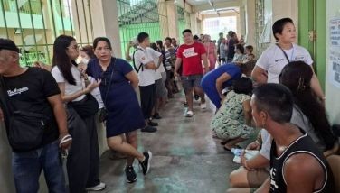 Voters wait in line at the San Jose Elementary School in Caloocan City to vote in the May 12, 2025 midterm elections.