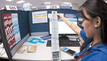 A student rvolunteer scans electoral returnsat the PPCRV command center in Manila on Tuesday.