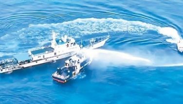 AGGRESSIVE INTERFERENCE: Screengrab from PCG video shows a China Coast Guard ship using a water cannon against a BFAR vessel conducting marine research near Sandy Cay the other day.