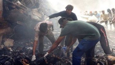 Rescue officials work at the site where Air India flight 171 crashed in a residential area near the airport in Ahmedabad on June 12, 2025.