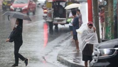 Pedestrians and motorists brave the sudden heavy downpour along EDSA in Quezon City on June 6, 2025. 