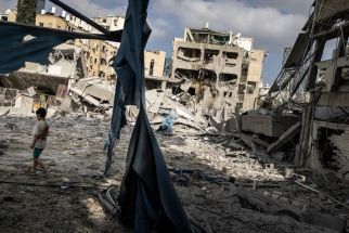 A young boy walks through the debris at the site of an Iranian missile strike in Bnei Brak, east of Tel Aviv, on June 16, 2025.