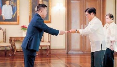 President Marcos accepts the credentials of Chinese Ambassador Jing Quan at Malacañang last December. Looking on is Foreign Affairs Secretary Maria Theresa Lazaro.