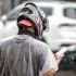 A man checks his cellphone during a sudden downpour that drenched Metro Cebu yesterday. Moderate to heavy scattered rainshowers continue to affect parts of the metro with the state weather bureau warning of floods and landslides in vulnerable areas. 