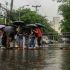 Pedestrians cross on a makeshift pathway along P. Burgos Street in Manila as gutter-deep floodwaters cover the road following a heavy downpour on September 6, 2025.