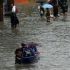 Residents wade through floodwaters along Zapote Junction in Las Piñas on Saturday morning, Aug. 28, 2026 as the flooded road remains closed to vehicles.