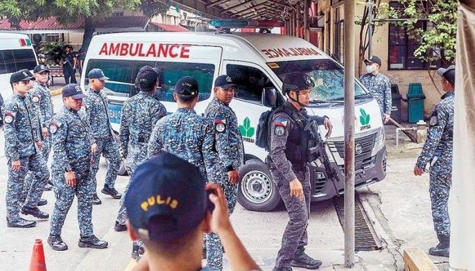Bureau of Jail Management and Penology officers escort an ambulance reportedly carrying former speaker Martin Romualdez as the convoy arrives at the Philippine General Hospital in Manila on September 12, 2026.