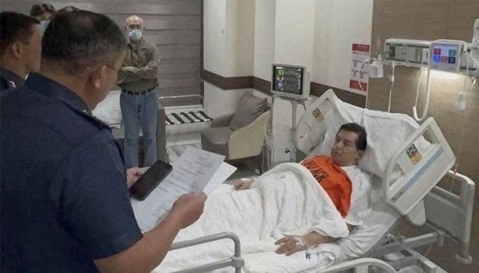 Rep. Martin Romualdez (Leyte) lies in a hospital bed at Cardinal Santos Medical Center as police place him under custody on Sept. 7, 2026, following the Sandiganbayan's issuance of a warrant in a P7.44-billion plunder case.