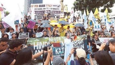 Groups join a protest against corruption at the EDSA Shrine in Quezon City yesterday ahead of the 54th anniversary of the declaration of martial law.