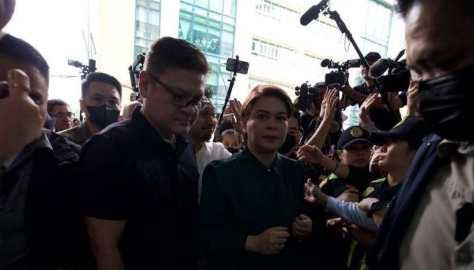 Vice President Sara Duterte arrives at the Quezon City Regional Trial Court on Sept. 11, 2026 for the arraignment of the three counts of grave threats filed by the Department of Justice against her. 